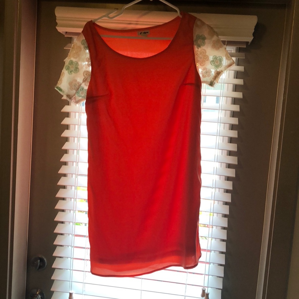 Coral shift dress with beaded floral sleeves.